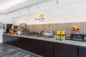 a kitchen with a counter with appliances on it at Days Inn & Suites by Wyndham Katy in Katy