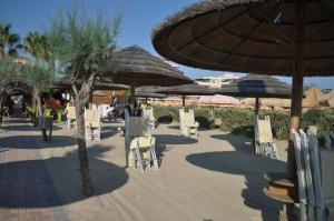 un gruppo di sedie e ombrelloni in spiaggia di Villa L'Aurora a Pescara