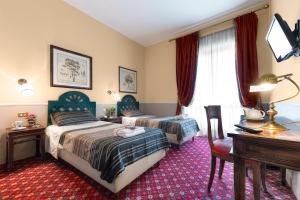מיטה או מיטות בחדר ב-Grand Hotel Colony