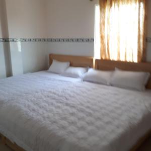 Postel nebo postele na pokoji v ubytování Cao Hung Hotel