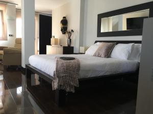 a bedroom with a large bed with white sheets at Casa Haisea 2 in Caleta De Velez