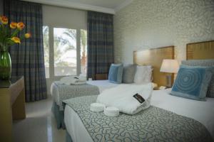 a hotel room with two beds with towels at Taba Sands Hotel & Casino in Taba +60 photos