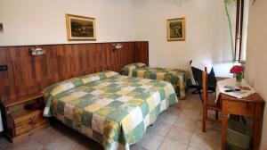 A bed or beds in a room at Albergo Santo Spirito