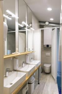 a bathroom with two sinks and a toilet at Gravitas Hostel in Split