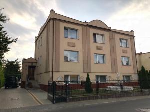 a large building on the side of a street at Kwatery prywatne Jaśmin in Gniezno