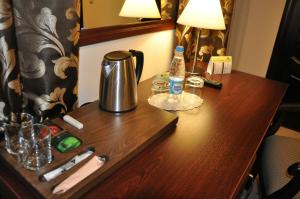 a desk with a coffee mug and a lamp at Bugar Hotel in Essentuki
