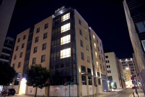 a building with lights on in a city at night at Downtown Hotel Apartments in Amman