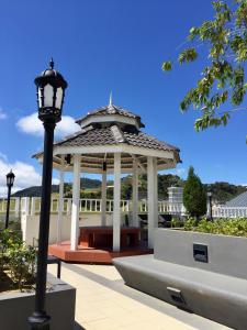 a gazebo with a light pole and a street light at Aalina's Comfort Home - Muslim Homestay in Cameron Highlands
