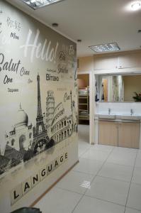 a kitchen with a wall mural offamous cities at Hostel Good Night in Kharkiv
