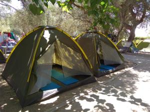 two tents are set up on the side of the road at Camping Koula in Parikia