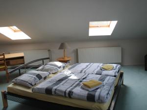 two beds in a room with skylights at Luxurious Apartment in Boddin with Garden in Boddin