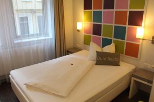 Postel nebo postele na pokoji v ubytování Altstadt Hotel Baunachshof