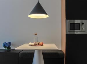 a kitchen with a table with a light on it at Furnas Lake Forest Living in Furnas