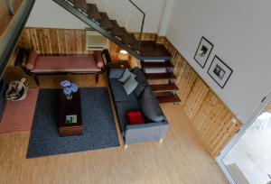 an overhead view of a living room with a couch and stairs at Furnas Lake Forest Living in Furnas