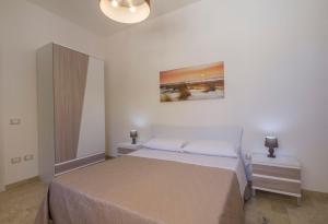 A bed or beds in a room at La Rosa Dei Venti