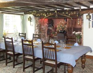 a dining room with a white table and chairs at Lower Ford Farm in Cullompton