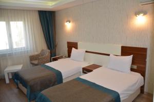 Ein Bett oder Betten in einem Zimmer der Unterkunft Grand Ahos Hotel