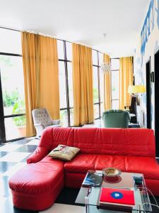 a living room with a red couch and a table at Green House in Kvareli