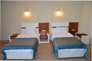 Ein Bett oder Betten in einem Zimmer der Unterkunft Grand Ahos Hotel