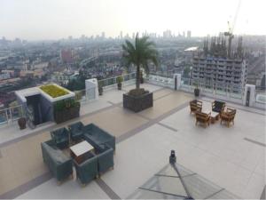 a balcony with tables and chairs on a building at Sta.Mesa across SM Model Unit 2 BR in Manila