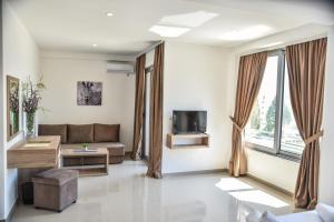 a living room with a couch and a tv at Vista Apartments in Ulcinj