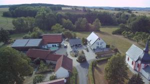 an aerial view of a house with a church at Ferienwohnung Wagner mit Terrasse und Kinderspielplatz in Küps