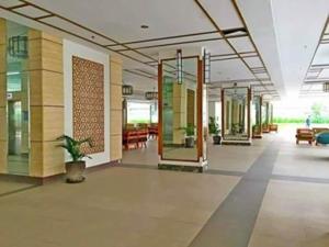 a lobby with doors and a potted plant in a building at Sta.Mesa across SM Model Unit 2 BR in Manila +21 photos