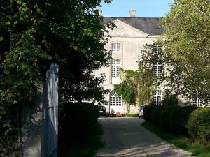 ein Haus mit einem Zaun vor einer Einfahrt in der Unterkunft L'Orangerie du Grand Jardin in Condé-sur-Seulles