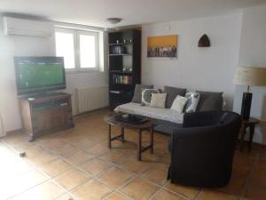 a living room with a couch and a tv at Apartment Burriana in Nerja