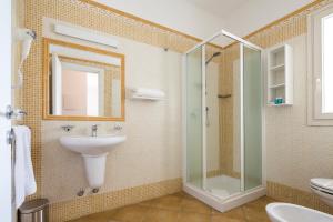 a bathroom with a sink and a glass shower at Acqua & Sale Hotel in Cervia +33 photos