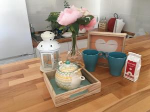 a table with a vase and a jar of flowers at Sunny Apartment Puerto Rico in Puerto Rico de Gran Canaria