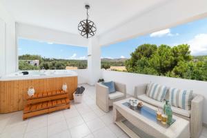 a patio with a tub and a couch and a table at Villa Bella with Private Pool and Hot Tub in Lartos