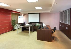 a conference room with a desk and a screen at Contessa Hotel in Shumen