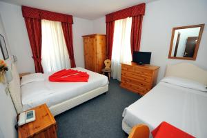 Postel nebo postele na pokoji v ubytování Hotel Capitani