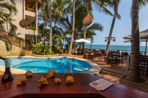 a resort with a swimming pool and a beach at Los Corales in Máncora