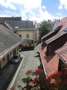 a car parked in a parking lot between two buildings at Gite "Karcher" in Colmar