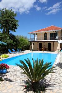 a swimming pool in front of a house at Villa Nefeli in Yenion
