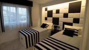 Posteľ alebo postele v izbe v ubytovaní Apartamentos Panorámicos Don Miguel II + 21 fotografií