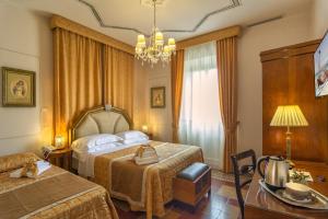 Postel nebo postele na pokoji v ubytování Lucca in Azzurro Maison de Charme