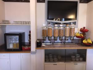 a kitchen with a shelf with jars of food at DC Lodge in Dawson Creek