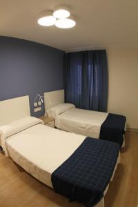 Postel nebo postele na pokoji v ubytování Hostal Mónaco