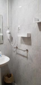 a bathroom with a shower with a phone on the wall at Pension San Marcos in Alovera