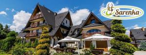 a large house with an umbrella in front of it at Sarenka in Białka Tatrzańska