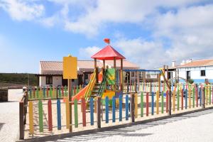 a playground with a slide and a play structure at Barranco da Fonte in Chabouco