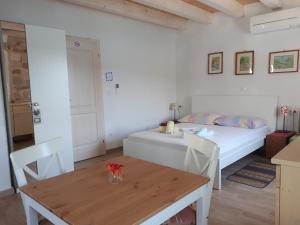 a bedroom with a bed and a table and a dining room at House at the seafront in Stari Grad