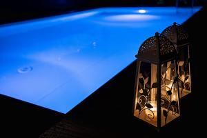 a lantern hanging in front of a swimming pool at Villa Vamagia BY APOKORONAS-VILLAS in Plaka