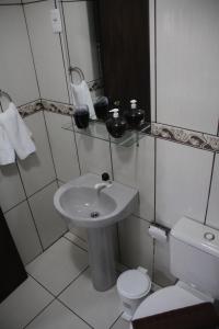Apartamento Bella Vista Gramado في غرامادو: حمام صغير مع حوض ومرحاض