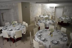 a room with tables and chairs with white tablecloths at Casa da Torre in Sobrosa