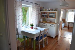 a kitchen with a table and chairs and a window at Dom Wakacyjny - Siedlisko Gutowo in Lidzbark