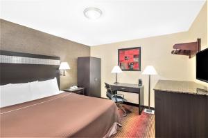 a hotel room with a bed and a desk at Howard Johnson by Wyndham Clifton NJ in Clifton